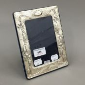 A silver Art Nouveau style frame