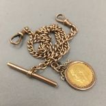 A 9 ct gold watch chain and bar with half sovereign,