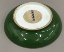 A Chinese porcelain green shallow dish