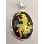 A silver pendant depicting a nude