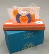 A boxed set of three Lalique perfume bottles