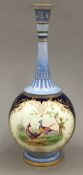 A fine blue scale Royal Worcester bottle vase painted with pheasants within panels.