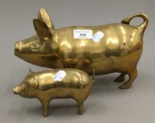 Two brass pigs