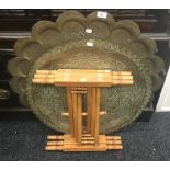 A folding brass topped table and two brass trays