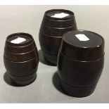 Three graduated turned treen barrel boxes and covers