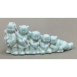 A Chinese porcelain brush rest formed as five boys