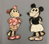 Two vintage needleworks depicting an early Mickey Mouse and Minnie Mouse