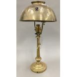 An Art Nouveau brass table lamp and a hinged brass wall light