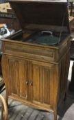 An oak cased gramophone and a quantity of records