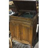 An oak cased gramophone and a quantity of records