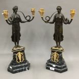 A pair of bronze Empire style candelabra