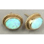 A pair of unmarked gold and opal earrings