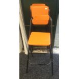 Three modern orange folding chairs