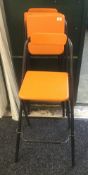 Three modern orange folding chairs