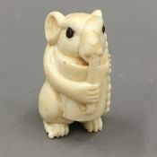 A bone netsuke formed as a mouse