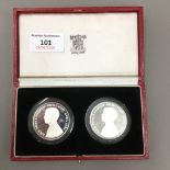 A pair of silver proof coins,