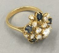 An 18 ct gold diamond and sapphire set ring,