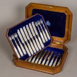 A Victorian burr walnut cased set of twelve mother-of-pearl handled silver dessert knives and forks,