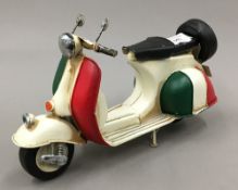 A tin model of a scooter