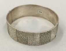 A silver bangle form bracelet