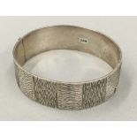 A silver bangle form bracelet