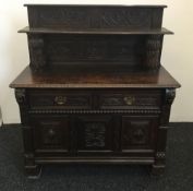 A Victorian carved oak side cupboard