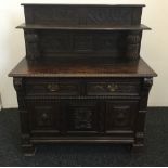 A Victorian carved oak side cupboard