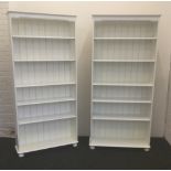 Two modern white painted standing bookcases