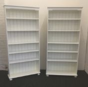 Two modern white painted standing bookcases