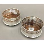 A pair of silver plated coasters