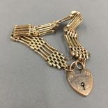 A 9 ct gold bracelet with a 9 ct gold padlock (18 grammes total weight)