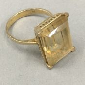 A 9 ct gold ring with pale yellow stone,