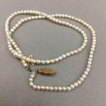 A seed pearl necklace with a 14 ct gold clasp