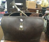 A vintage doctor's Gladstone bag, together with a pair of leather gaiters, swagger stick,