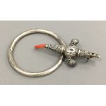 A Victorian unmarked silver child's rattle and a bangle