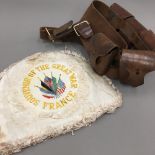 A leather ammunition belt and tea cosy embroidered ''Souvenir Of The Great War,