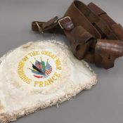 A leather ammunition belt and tea cosy embroidered ''Souvenir Of The Great War,