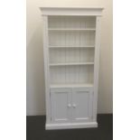 A modern white painted bookcase/cupboard