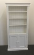 A modern white painted bookcase/cupboard