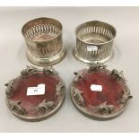 A pair of silver plated bottle coasters with elephant mounts,