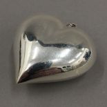 A large plain silver heart pendant