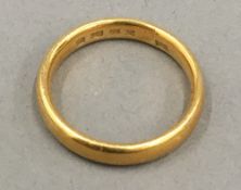 A 22 ct gold wedding band (5 grammes total weight)