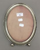 An oval silver photograph frame