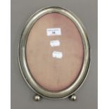 An oval silver photograph frame