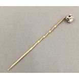 A diamond set unmarked gold stick pin