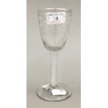 An early 19th century engraved air twist stem wine glass