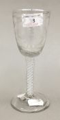 An early 19th century engraved air twist stem wine glass