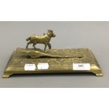 A brass desk clip mounted with a sheep