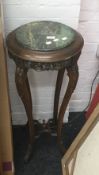 A marble inset top carved wood jardiniere stand