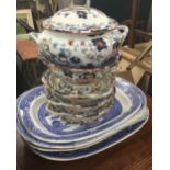 Four 19th century blue and white willow pattern meat plates together with 19th century tureens,